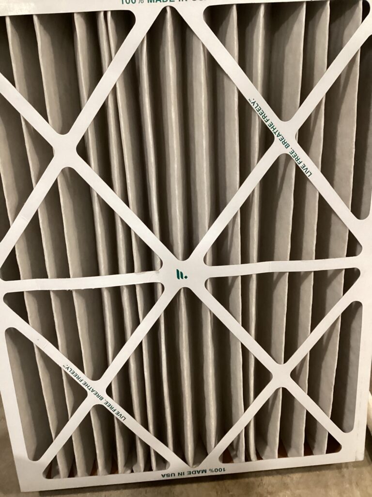 An HVAC filter in a white frame
